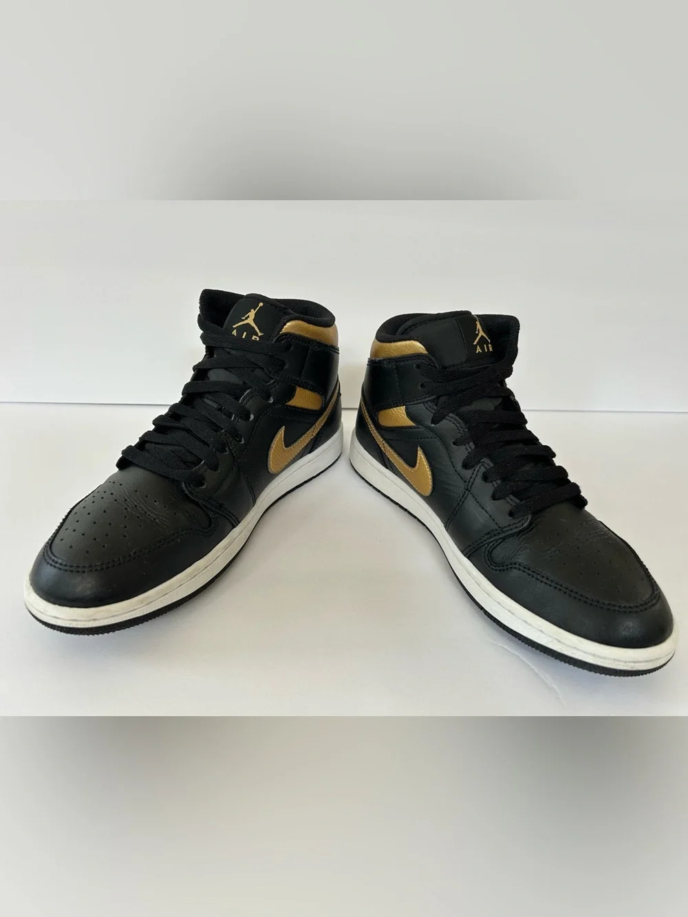 Air Jordan Black and Gold High-Top Sneakers
